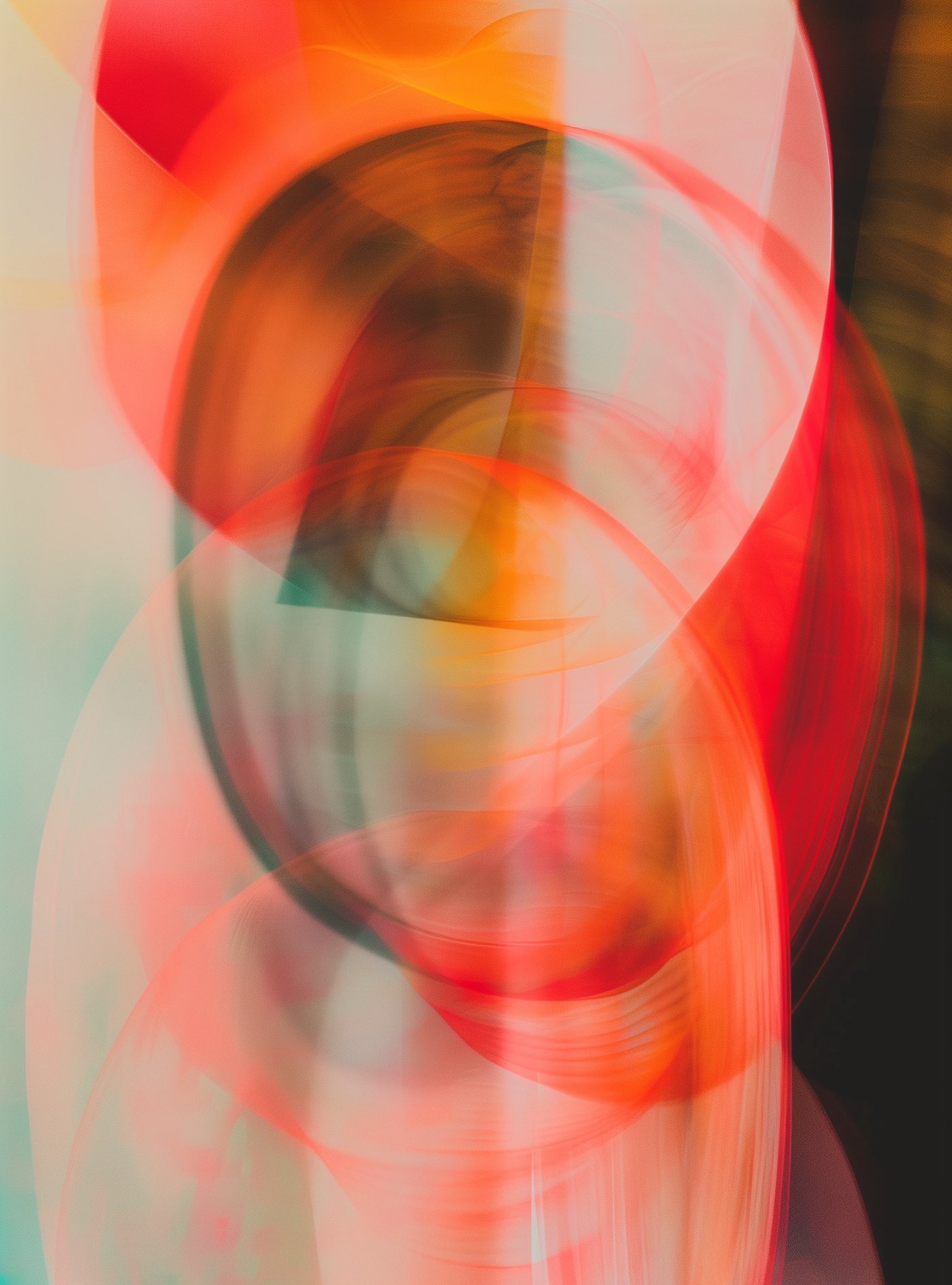 Abstract overlapping arcs of coral, red and teal light